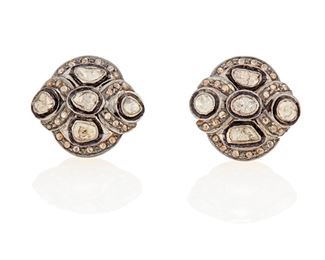 282
A Pair Of Indian Diamond Earrings
Silver and vermeil
Set with ten tablet-cut diamonds largest gauged at 5.6mm x 2.8mm each graded yellow and brown in color and I2/I3 in clarity surrounded by forty-eight rose-cut diamonds each graded yellow and brown in color and I1/I2 clarity with post and push backings
0.75" Dia
9.7 grams
2 pieces
Estimate: $600 - $800
