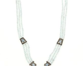 283
An Aquamarine And Diamond Necklace
Silver-topped 18k yellow gold
Comprising a triple strand faceted bead aquamarine necklace each stone gauged at 3.4mm in diameter further set with five oval mixed-cut aquamarines ranging in size from 7.8mm x 5.4mm to 10.7 x 6mm and one triangular aquamarine gauged at 6.3mm in diameter all with a total approximate weight of 5.00cts. and additionally set with one hundred twenty-three round full-cut diamonds totaling approximately 2.00cts. in weight and graded light brown in color and VS/SI clarity
16" L x 0.50" W (approximately)
35.7 grams
Estimate: $1,200 - $1,800