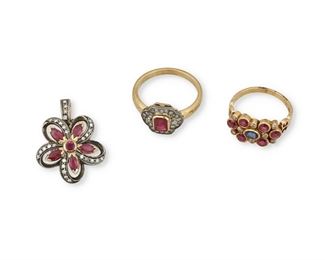 302
A Group Of Ruby, Sapphire And Diamond Jewelry Items
18k yellow gold and silver; Variously stamped/scratched: 750 / 100 / 750
Including an 18k yellow gold ring centering one oval mixed-cut sapphire gauged at 4.3mm x 3.4mm x 2.1mm weighing approximately 0.25ct. surrounded by six round mixed-cut rubies each gauged at 3.5mm with a total weight of 1.40cts. further accented by eight round full-cut diamonds totaling approximately 0.20ct. and graded light brown and SI clarity (ring size: 6.5; 0.375" H) , a silver topped 18k yellow gold ring centering a bezel set rectangular step-cut ruby gauged at 6mm x 4mm x 2.7mm weighing approximately 0.65ct. further accented by twenty-four round single-cut diamonds totaling approximately 0.30ct. in weight and each graded J-K in color and VS/SI clarity (ring size: 8; 0.50" H) and a silver topped 18k yellow gold flower pendant comprising of five marquise-cut rubies and one round ruby totaling approximately 0.90ct. further surrounded by twenty-nine round 