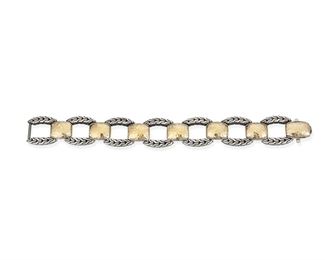 310
A John Hardy Silver And Gold Bracelet
22k yellow gold and sterling silver; Stamped: 22k / 925 / John Hardy logo
An oval link bracelet designed with hammered 22k yellow gold links alternating with oval braided sterling silver links
0.75" W x 7.5" L
51.1 grams
Estimate: $600 - $800