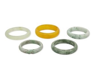 313
A Group Of Five Jade Bangle Bracelets
Including a translucent green jade round bangle gauged at 12.8mm wide (7.5" Cir), a mottled green jade bangle gauged at 16mm wide (7.25" Cir), a mottled green jade bangle gauged at 14.7mm wide (7.375" Cir), a carved mottled green jade bangle gauged at 13mm wide (7.0" Cir) and a golden jade bangle gauged at 20mm wide (8" Cir)
5 pieces
Estimate: $600 - $800