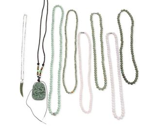 322
A Group Of Six Jade Necklaces
Silver; Pendant stamped: Silver; Chain stamped: 925
Including two strands of green jade beads and two strands of pink jade beads each gauged at 6mm - 7.9mm each with matching white metal clasps (21.0" L - 22.0" L), a green jade bead necklace gauged at 5.7mm accented with a yellow metal bead (24.0" L) a green jade bead necklace gauged at 7mm with a costume clasp (30.0" L), a green jade dragons pendant topped with additional colored jade beads on a black cord (1.50" W x 2.0" H x 32.0" L) and a silver jade tiger tooth pendant (0.375" W x 1.875" H) on a detachable silver neck chain (18.0" L)
9 pieces
Estimate: $100 - $200