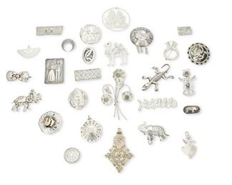 364
A Mixed Group Of Silver Jewelry
20th century
Most marked for silver; Four marked for Mexico
Comprising a large group of jewelry including eighteen brooches, five brooch/pendants, and four pendants, one with shell inlay, three with small set stones; all in various designs and motifs, such as floral, foliate, and geometric, with figural characters and animals such as elephants and a camel, 27 pieces
266.5 grams
Estimate: $300 - $500
