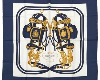 371
A Hermès "Brides De Gala" Silk Scarf
Mid-20th Century or Later
Unsigned, no tag or fabric label
Designed by Hugo Grygkar, first issued in 1957, with two elaborately embellished bridles with blinkers and reins in navy blue, gold and cream with central inscription: "Brides de Gala par Hermès Paris"
35.0" H x 35.0" W
Estimate: $200 - $300