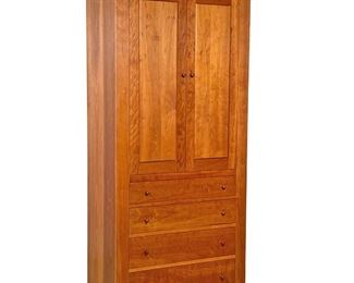 THOMAS MOSER CHERRY CABINET  |  
Having cabinet doors, revealing an interior with adjustable shelves, and hanging rod over for graduated, full width drawers with turned wood poles - l. 20 x w. 34 x h. 76 in.