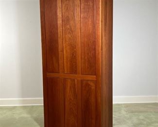 THOMAS MOSER CHERRY CABINET  |  
Having cabinet doors, revealing an interior with adjustable shelves, and hanging rod over for graduated, full width drawers with turned wood poles - l. 20 x w. 34 x h. 76 in.