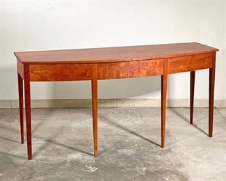 THOMAS MOSER SIDEBOARD  |  
Figured American cherry wood, having a bowed front with three drawers raised on six straight tapering legs - l. 72 x w. 24 x h. 34 in.
