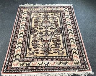 ROYAL UZBEK WOOL RUG  |  
Retailed by RH Macy & Co, having a geometric pattern with vines flowers and animals on a cream filled and signed in reserve at one end, wave border both fringes - l. 77 x w. 50 in.