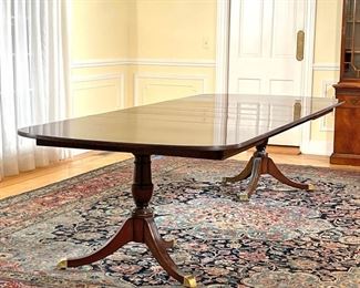 KINDEL FLAME MAHOGANY DINING TABLE  |  
"Oxford" double pedestal dining table, with beautiful highly figured and well matched flame mahogany top. Interior extension, mechanism, and storage for four leaves (each leaf 12 inches). Length with no leaves in; 72 in -
l. 120 x w. 46 x h. 28 in. (fully extended)