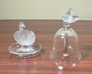 (2pc) LALIQUE FROSTED GLASS  |  
Including a ring dish with central frosted glass swans and a crystal glass bell with a frosted bird finial (h. 5.5 in.)
