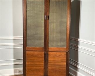 MID CENTURY CABINET  |
Upper cabinet doors having beveled glass with grill work over lower double cabinet doors with brass retaining hardware - l. 40 x w. 14 x h. 70.75 in.