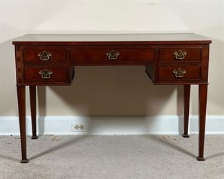 BAKER WRITING DESK  |
With two banks of two small drawers centering same middle drawer, with blind fretwork decoration, and a nicely figured contrasting wood top, on square tapering legs - l. 45.5 x w. 21.5 x h. 29.5 in.
