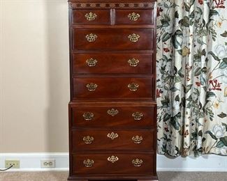 BAKER NARROW DRESSER  |
Designed in two sections, appearing to be of one piece construction, the upper section with two drawers over three full with drawers, the lower section with three full with drawers, with brass hardware and blind fretwork - l. 24.75 x w. 16.5 x h. 53.75 in.
