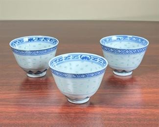 (3pc) CHINESE BLUE AND WHITE CUPS  |
Porcelain cups with blue and white pass-through decoration, each with underglaze blue on th bottom - h. 2 x dia. 3 in.