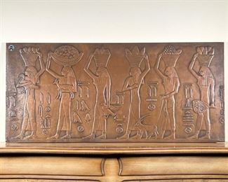 EGYPTIAN STYLE METAL PLAQUE  |
"Ateliers d'Art Francais / Cuivre" heavy wall hanging showing women carrying offerings, with a French label upper left and on verso - w. 41 x h. 18.75 in.