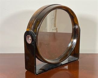 ACRYLIC VANITY MIRROR  |
Faux tortoiseshell brown acrylic, with magnifying mirror and regular mirror, swiveling - l. 9.25 x h. 9.25 in.
