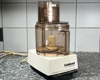 SHIRLEY SONTHEIMER'S MONOGRAMMED CUISINART DLC-7 PRO  |
A Cuisinart food processor with several attachments and many blades and other attachments, some new in box - h. 12 in. (processor unit as pictured), monogramed "SMS"
