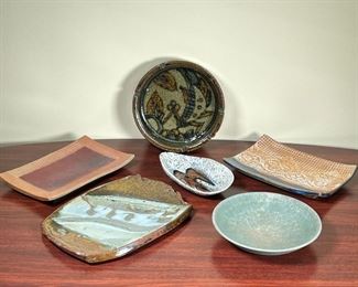 (6pc) MISC POTTERY TRAYS  |
Including a green ashtray with design on the inside (dia. 7 1/4 in. x h. 2 in.) , a brown tray with white and green glaze details, and other misc trays - l. 10 x w. 7 1/4 in. (largest)
