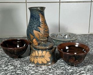(5pc) POTTERY ITEMS  |
Including a lidded jar and a pitcher both signed with initials on the bottom, a pair of Japanese style brown glazed bowls signed with initials DP on the bottom, and a light blue/gray pedestal bowl with openwork rim (dia. 5.25 in.) - h. 7.75 in. (pitcher)