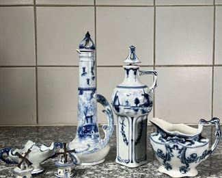 (6pc) DELFT & OTHER PORCELAIN  |
Including two Delft figural pitchers with a blue underglaze decoration and both signed on the bottom, a pair of windmill form salt and pepper shakers, a small double handled bowl with marking on the bottom, and a Staffordshire open creamer pitcher - h. 10.75 in. (tallest)
