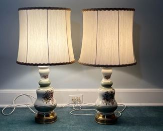 (2pc) PAIR PORCELAIN TABLE LAMPS  |
Green and white porcelain table lamps with transfer ware floral decoration with textured embellishments, on brass openwork stands and with grand shades - h. 29.5 x dia. 15 in.