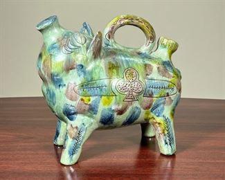 ART POTTERY PIG  |
Colorful pottery pig, appearing to be a watering can, appears to be unsigned - l. 10 x h. 8 1/2 in.