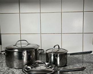 (3pc) CUISINART COOKWARE  |
Stainless steel, including an 8.25 inch Cuisinart frying pan and lid (lid not perfectly fitting), an unmarked 6.25 inch pot, and an unmarked 10.25 inch pot, three lids in total