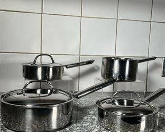 (4pc) CUISINART POTS  |
Stainless steel cookware, three of the pots marked Cuisinarts, one pot unmarked but with same handle, including three lids, including A 7 inch shallow pot a 7.5 inch shallow pot, a 6.75 inch sauce pan, and a 9 inch shallow pot
