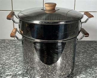 STAINLESS STEEL STEAMING POT  |
Stainless steel with wood handles, no apparent markings, a 7.25  inch tall pot with a 10.75  inch steaming insert, the lid only fitting the steam top