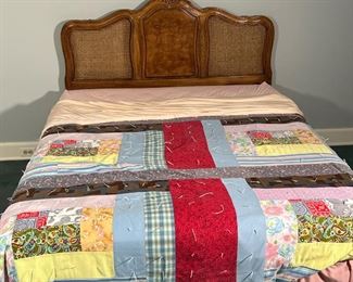 QUEEN CANED BEDFRAME  |
Carved wood headboard with caning, nicely figured burled wood, no footboard, with metal rails/mattress support - l. 71 x w. 60 x h. 47.25 in. [n.b. mattress and boxspring not included]
