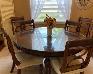 Round dining table with 6 chairs.  There are two matching bar stools.