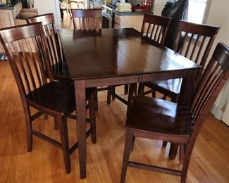 bar height dining table with 6 stools.  54" long x  36" wide x 36" tall
