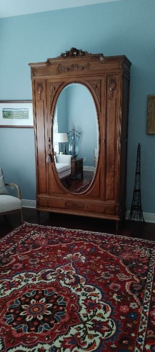 Walnut armoire with oval front mirror