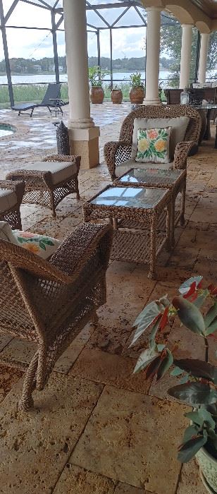 Beige wicker lounge chairs and ottomens