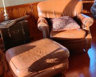 Pair of brown leather lounge chairs, one ottoman