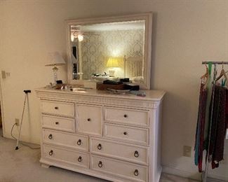 Dresser in bedroom suite with king bed, bedside tables, headboard, and gentleman’s chest.
