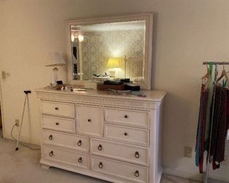 Dresser in bedroom suite with king bed, bedside tables, headboard, and gentleman’s chest.