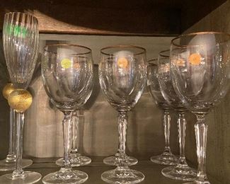 Gold trimmed wine glasses and champagne flutes.