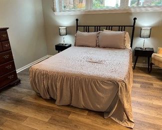 Queen sized bed with metal headboard