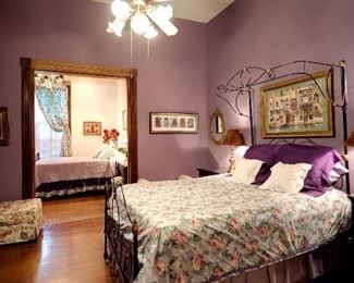 Metal and brass half tester bed from Louisiana plantation home dating to 1880's. Adapted for queen size, mattress and box springs included. Hassock, arm chairs.