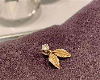 SOLD Marked 14K Gold, petite leaf pendant with authentic diamond center. Measures 1/2" in length. Hangs with the diamond at the top, leaves facing down, as shown. 