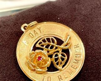 $220. Marked AC14K Gold, vintage commemorative date pendant marked "A Day to Remember." There is a date from the 60's lightly etched on back. This can be removed by your jeweler.  Approx 28MM diameter. 