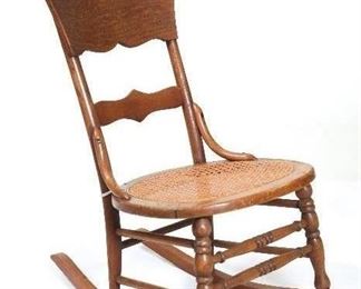 Antique American Oak Sewing Rocker with Serpentine Panel Back Cane Bottom Seat, Turned Legs and Stretcher