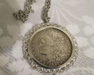 1921 Morgan silver dollar encased with silver bezel and sterling chain. $95