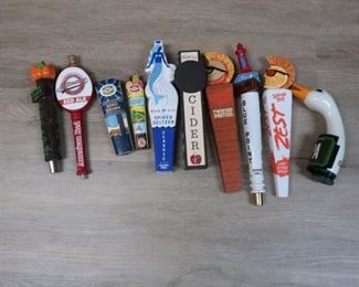 134.  ten assorted tap handles    100.00