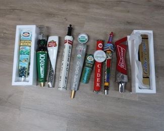 135.  ten assorted tap handles   100.00