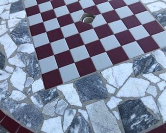 Concrete patio table and benches. Tiled, with checkerboard.