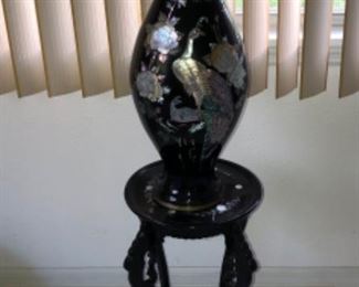 Enameled brass vase with inlaid abalone and mother of pearl. Enameled wood table stand, carved and inlaid mother of pearl