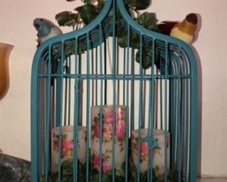 Decorative bird cage with candles and birds
