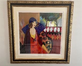 Hall:  An Isaac (Itzchak) Tarkay (1935-2012) serigraph (2002) titled "Indigo Chapeau" has a double mat and ornate gold frame.  It is signed in the plate and measures 38" x 38," including the frame. Tarkay was born in 1935 on the Yugoslav-Hungarian border.  When he was 9, Tarkay and his family were sent to the Mathausen Concentration Camp by the Nazis. They survived until the Allied Liberation freed them one year later.  His family then immigrated to Israel where they had to live in a kibbutz for several years.  Tarkay is a listed artist most recognized as a leading representative of figurative art, with much of his work inspired by French Impressionism and Post-Impressionism.  He liked the colors of Matisse and the drawing style of Toulouse-Lautrec.  It should be noted that he was the only artist to collaborate with Israeli master Yaacov Agam with whom he created two paintings.   A Certificate of Authenticity is on the reverse side.